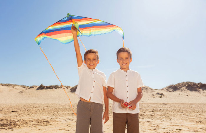 Twin brothers on a beach.