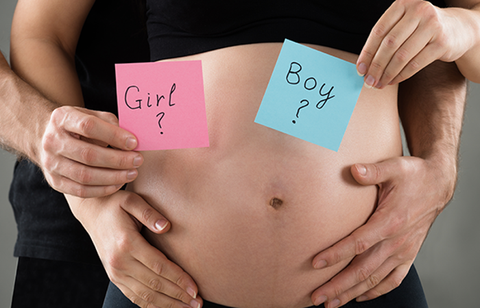 Young couple expecting with a close-up on their mid section.