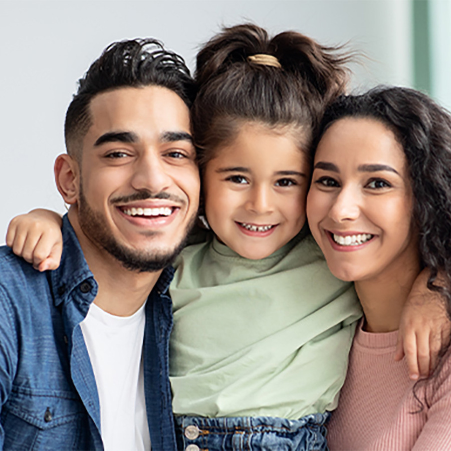 A happy child with their mother and father.