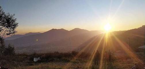 Sun behind mountains