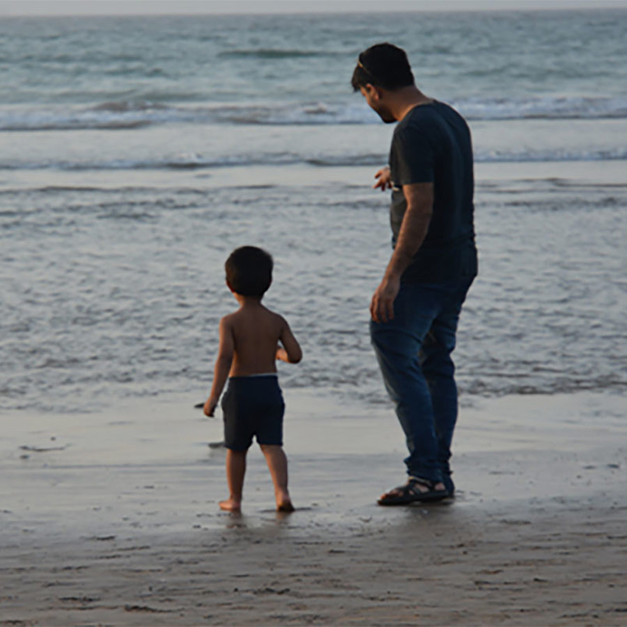 Man and child on a beach.