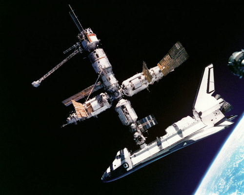 Space shuttle docking on space station.