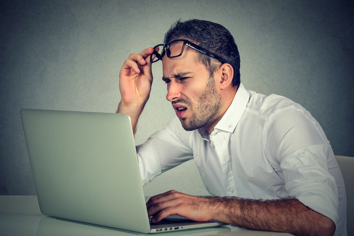 Confused man at computer.