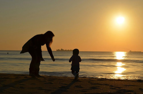 A mother with her child at the beach.