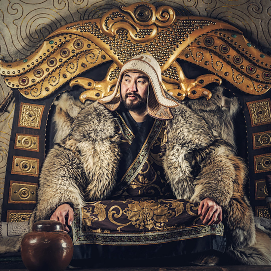 Genghis Khan sitting at his throne.