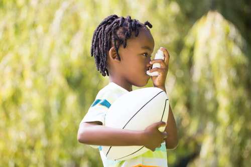 Boy with inhaler.